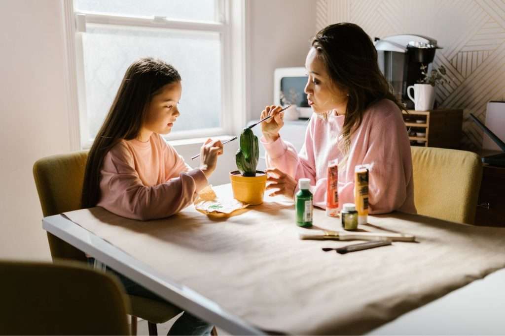 Mom supporting her daughter in her art project