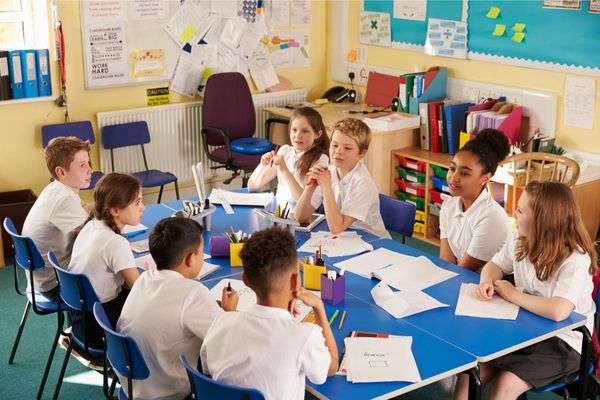 Children discussing social project among themselves 