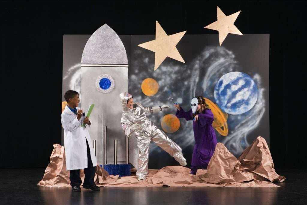 Kids in drama competition, dressed as astronaut, scientist & alien