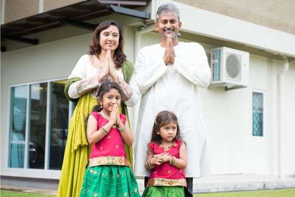 Indian Family with kids doing Namaste