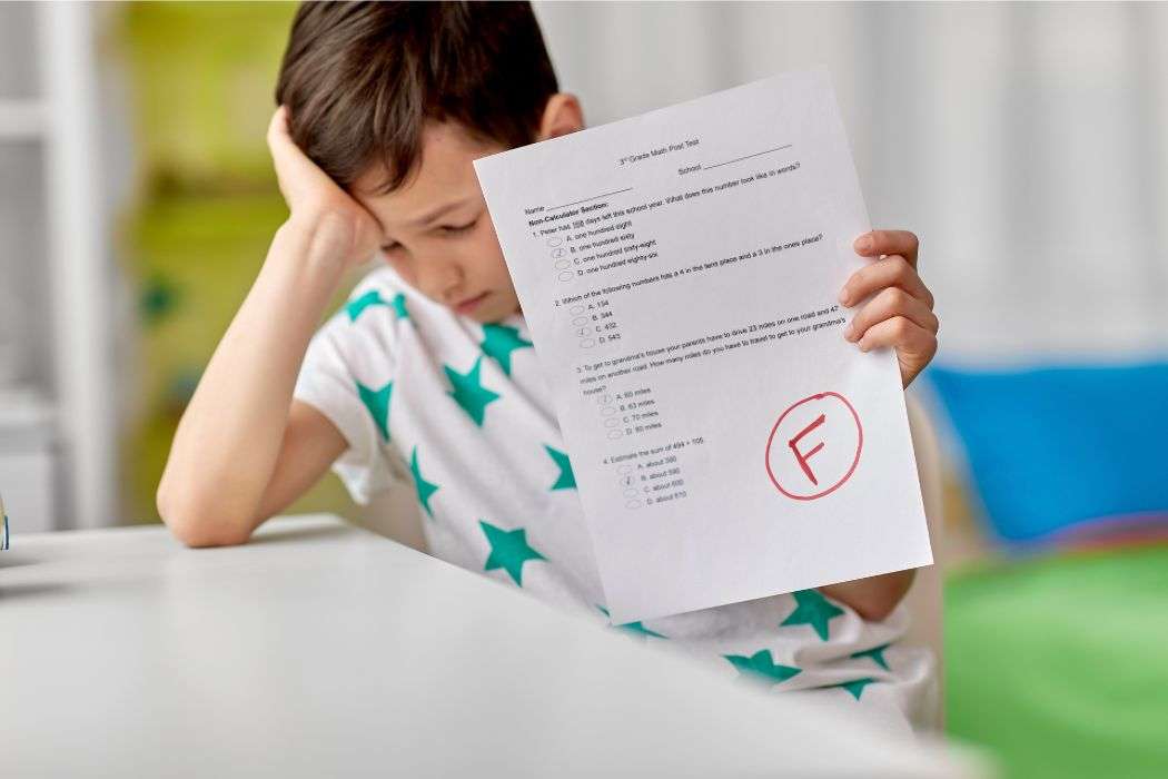 disappointed child with failed report card