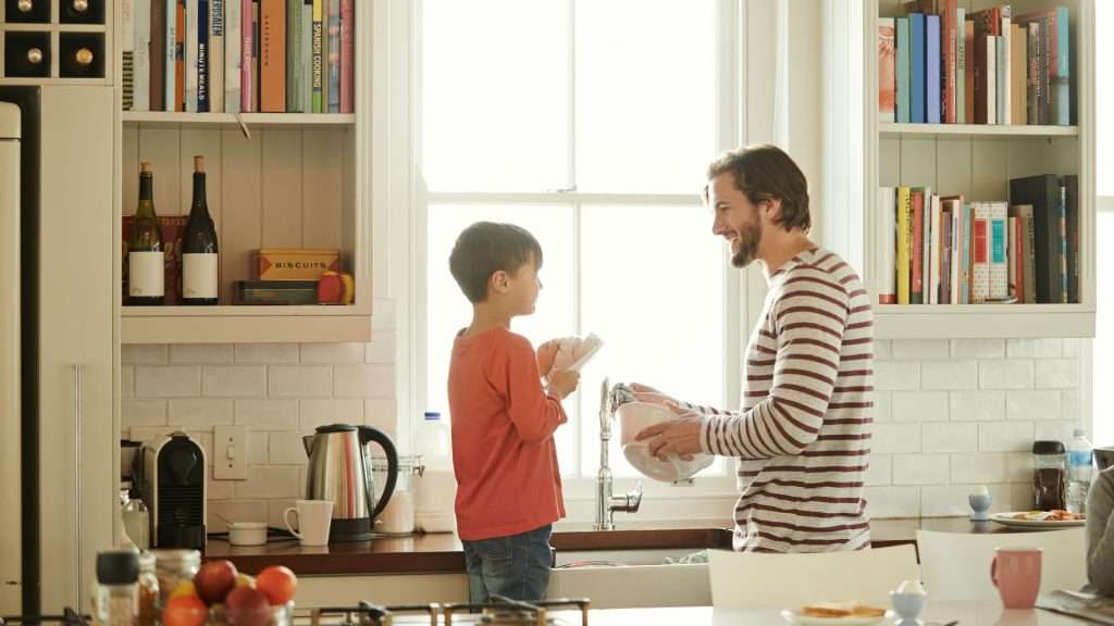 Father teaches son to do housework