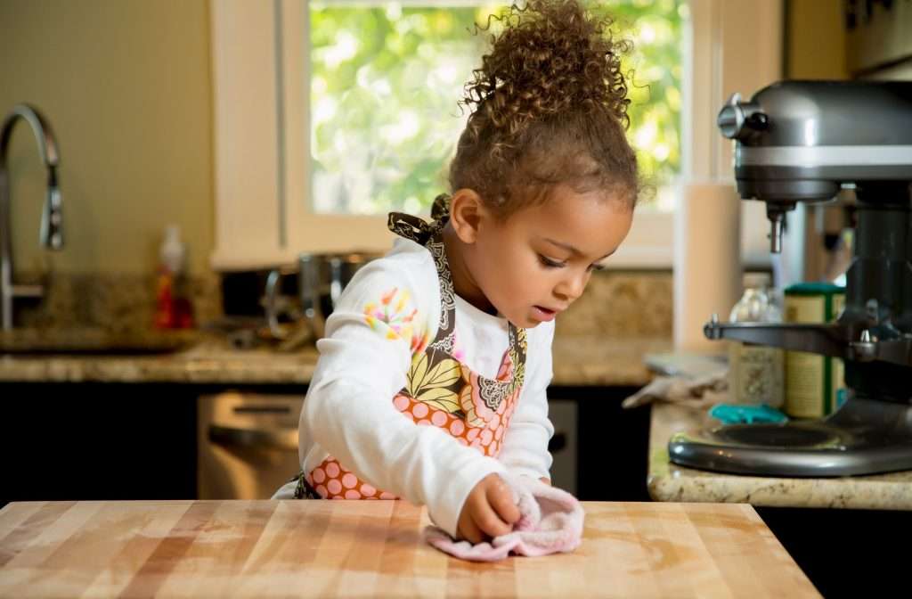 The little girl clearing the table after the meal